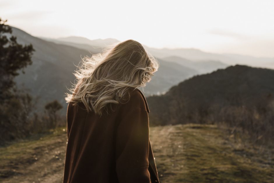Randonneuse marchant sur un sentier de montagne au coucher du soleil